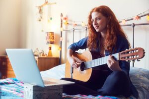Red headed teenager playing guitar