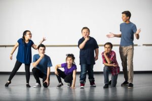 Group of kids acting in a drama class