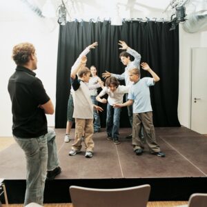 Group of students acting for a drama class