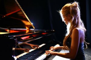 Side view of a blonde female pianist