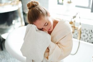 Young woman wiping her face after taking a bath