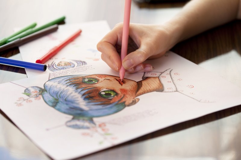 Close up of an artist working an anime drawing