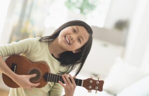 Little girl playing easy ukulele songs