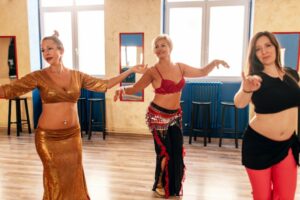 Three women belly dancing together
