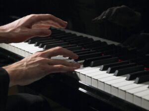 Close up of hands playing the piano