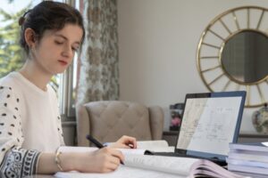 Teen girl working on her math homework online