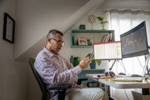 Economics tutor working in his home office