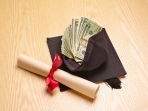 Picture of a graduation cap filled with money and a diploma