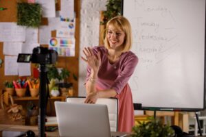 Confident female teacher standing in a classroom